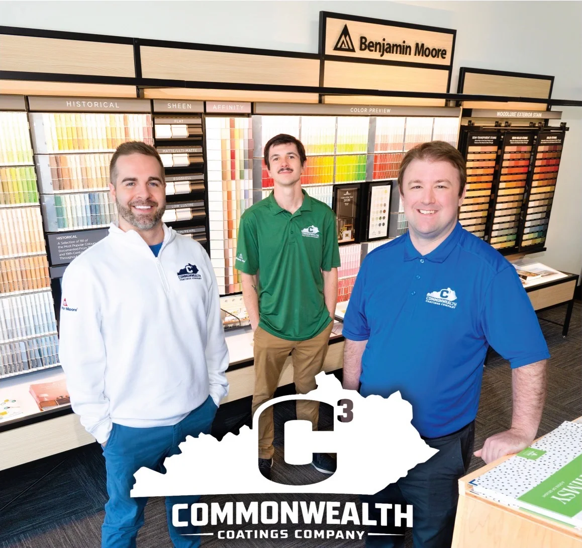 The Commonwealth Coatings Company team in front of the Benjamin Moore color wall at the Palomar Centre store